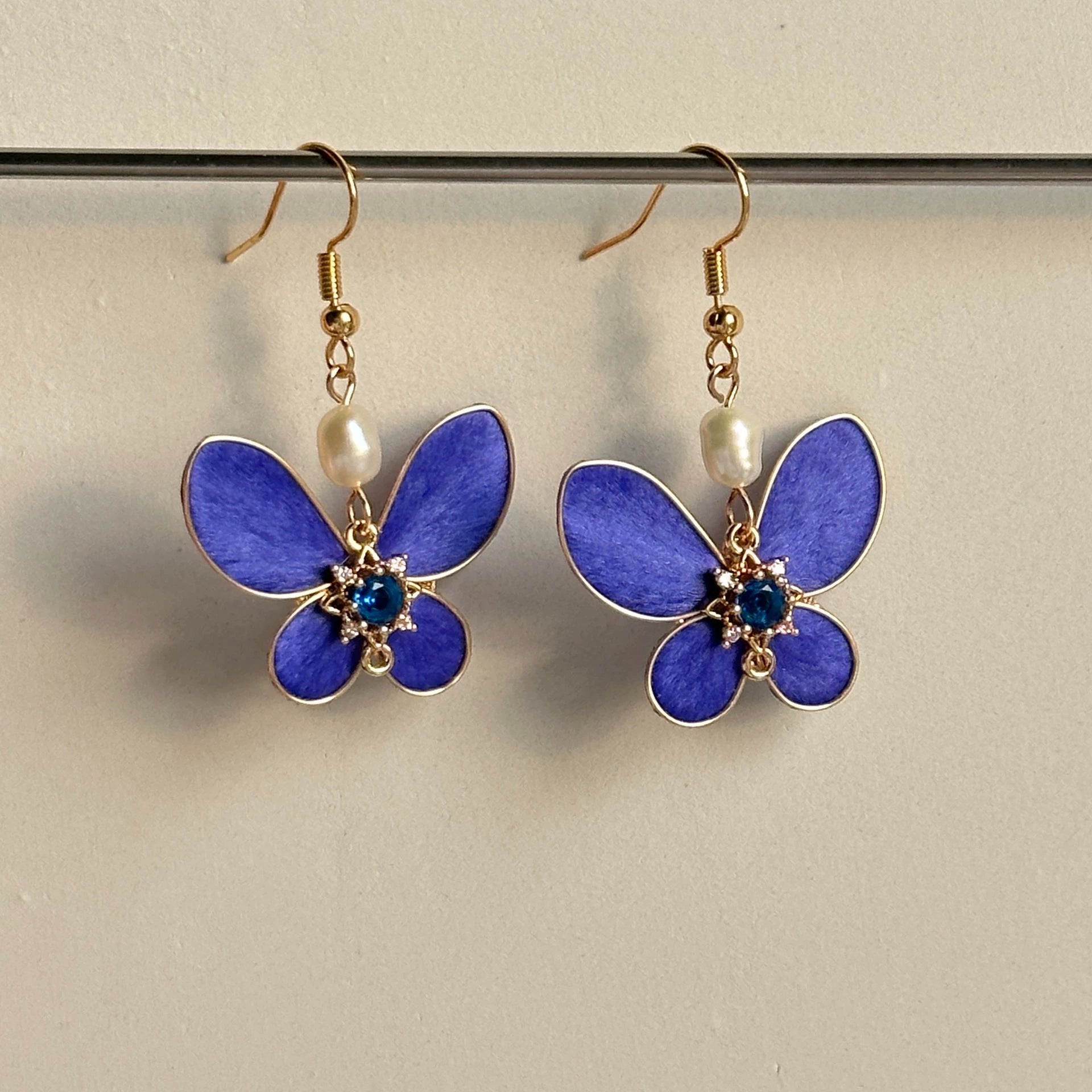 Handmade Ronghua royal blue silk velvet butterfly drop earrings with freshwater pearl and blue crystal center on gold hooks