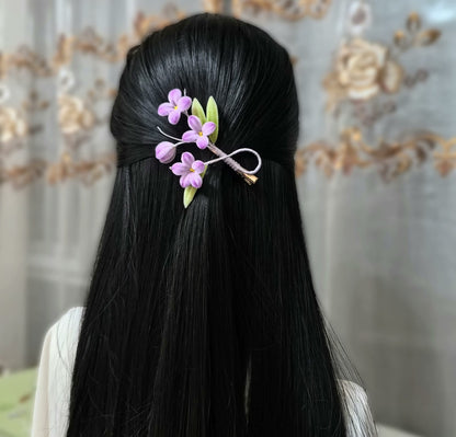 Handmade Ronghua purple lilac flower hair clip worn in black hair – natural mulberry silk velvet floral alligator clip