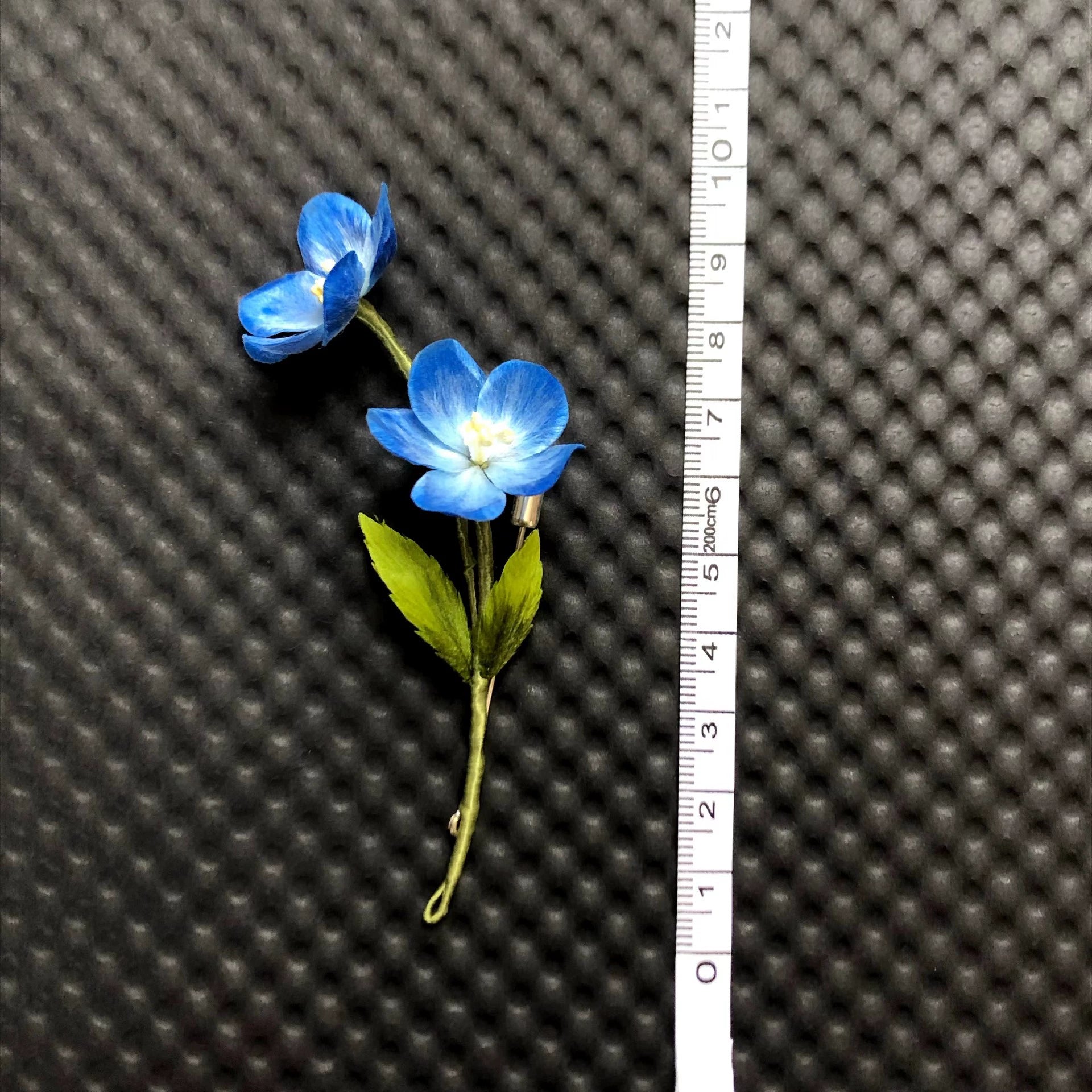 Ronghua star flower lapel pin worn on dark suit – lightweight silk floral accessory for hanfu and weddings