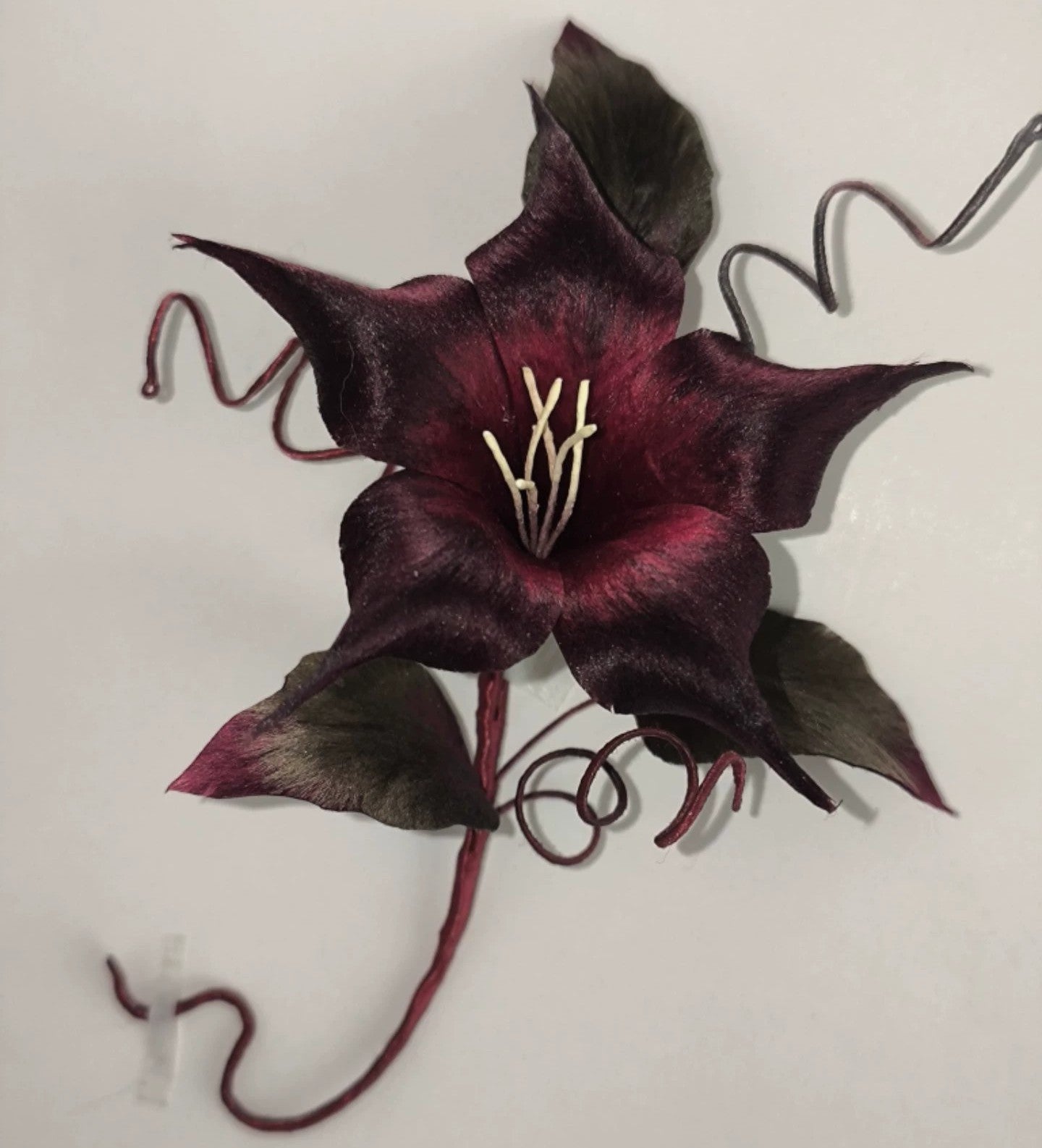 Ronghua oversized black datura brooch worn on dark coat – lightweight silk statement pin for hanfu and formal wear